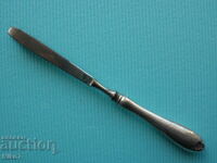 Antique tweezers with a silver handle.