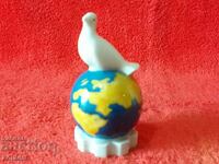 Old porcelain figure White Dove on Globe Globe