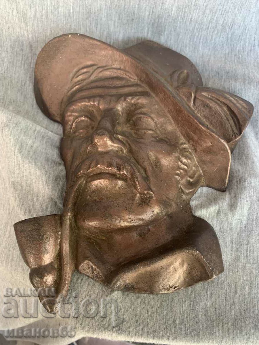 cast iron figure of an old man with a pipe
