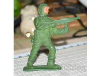 Old plastic retro soldier figure with machine gun