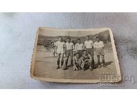 Photo Young people in sports equipment with a vintage soccer ball