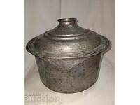 Old copper pot with lid and seal