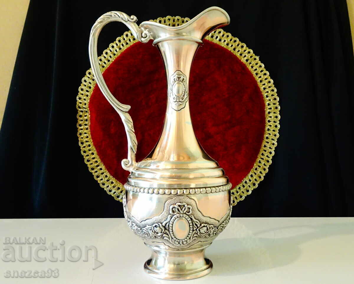 Silver-plated copper jug, roses, ornaments. Silver-plated copper jug, roses, ornaments.