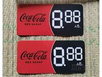 Două etichete publicitare și Coca-Cola fără zahăr