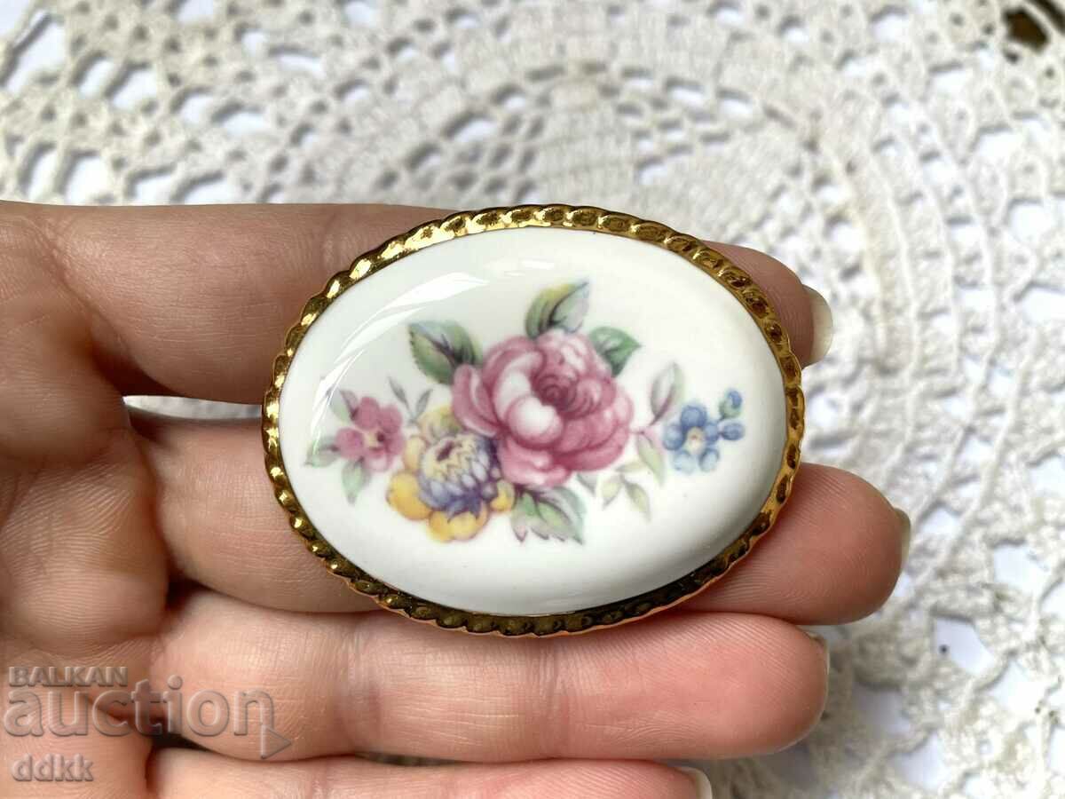 A beautiful large porcelain brooch from England with gold edging