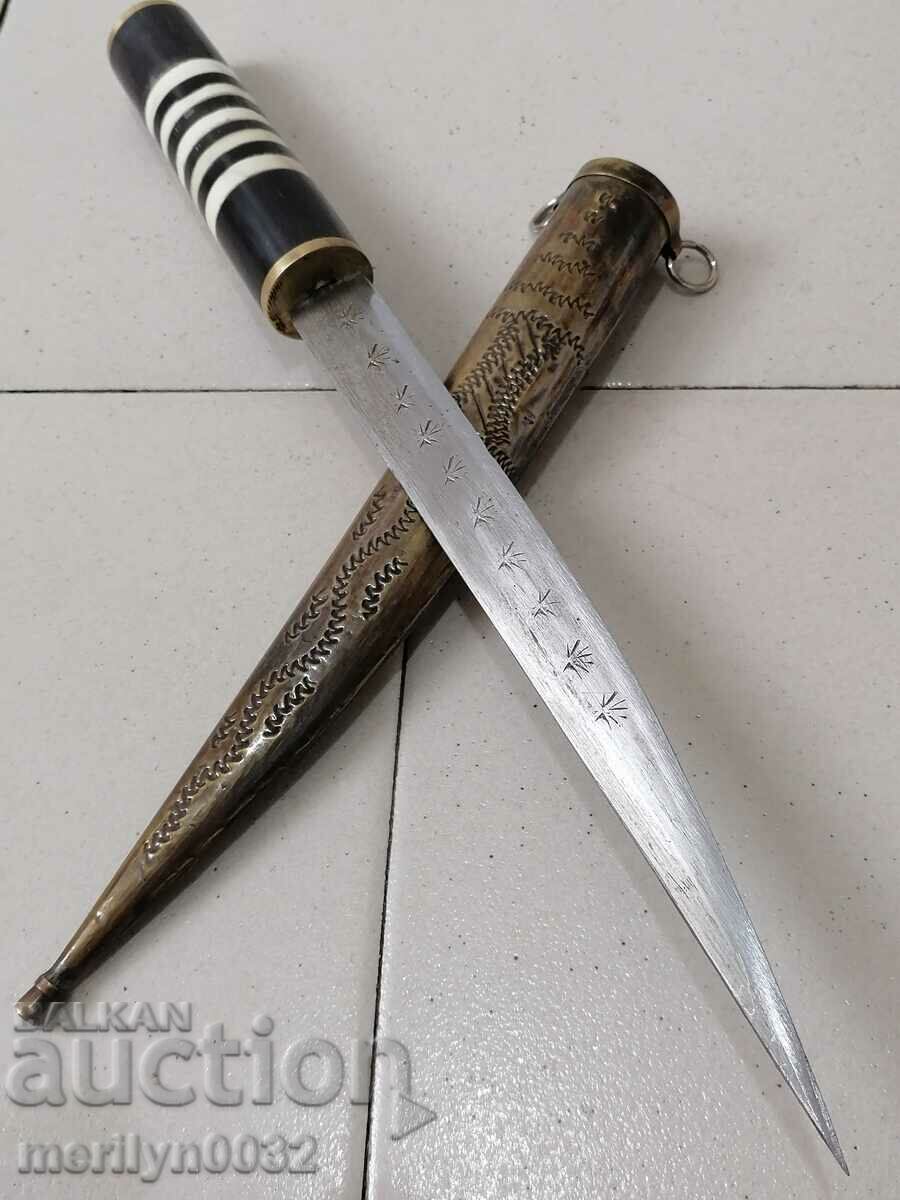 An old dagger with a kaniya knife with a tanned buffalo horn blade