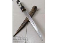 An old dagger with a kaniya knife with a tanned buffalo horn blade