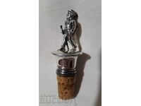 Old silver-plated cork with a plastic figure