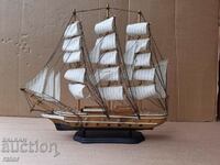 A large handmade model of a warship, a small ship