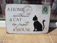Μεταλλική πινακίδα που λέει το Home without a cat is just a kitten house