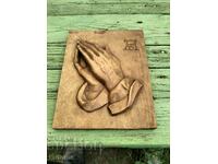 Wooden panel of praying hands