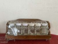 Wooden wall rack with glass spice shakers