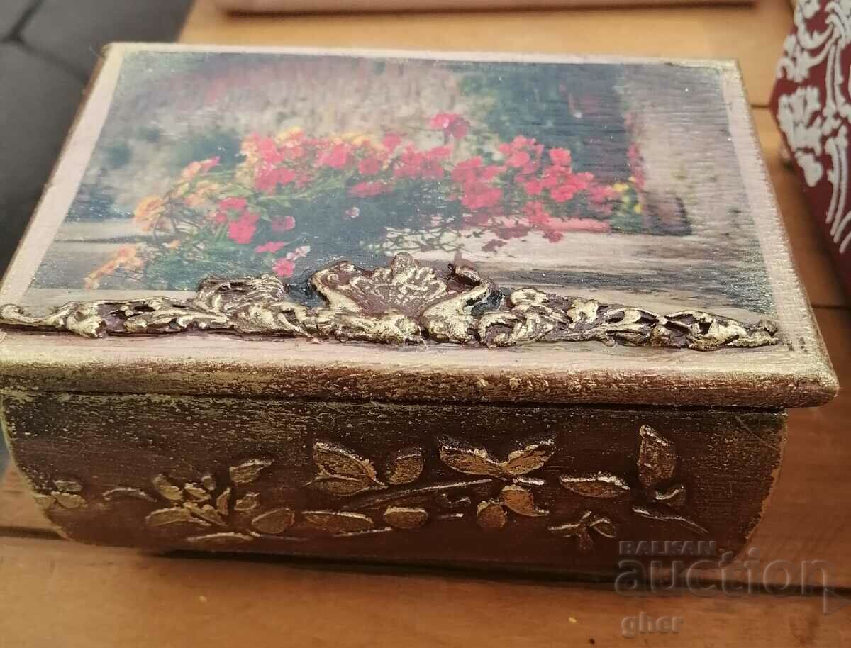 Vintage wooden jewelry box with gilded ornaments.