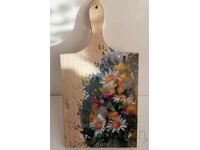 A beautiful souvenir cutting board with flowers.