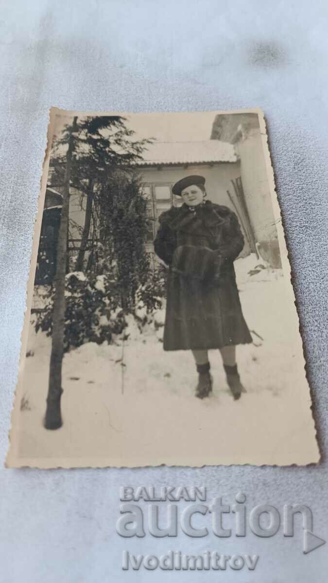 Photo Woman in the yard of a house in the winter of 1939