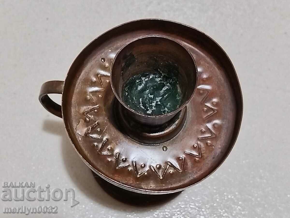 Delivery of Old wrought copper candlestick from the social period, candle