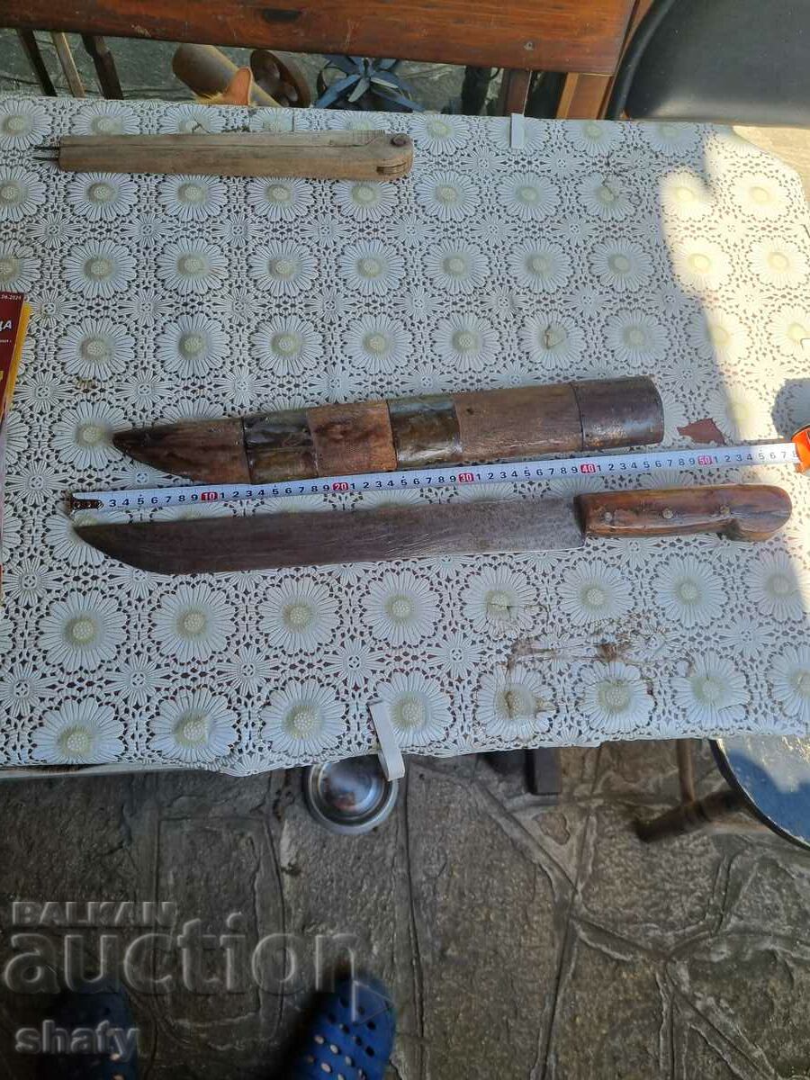 A huge old knife with a wooden handle