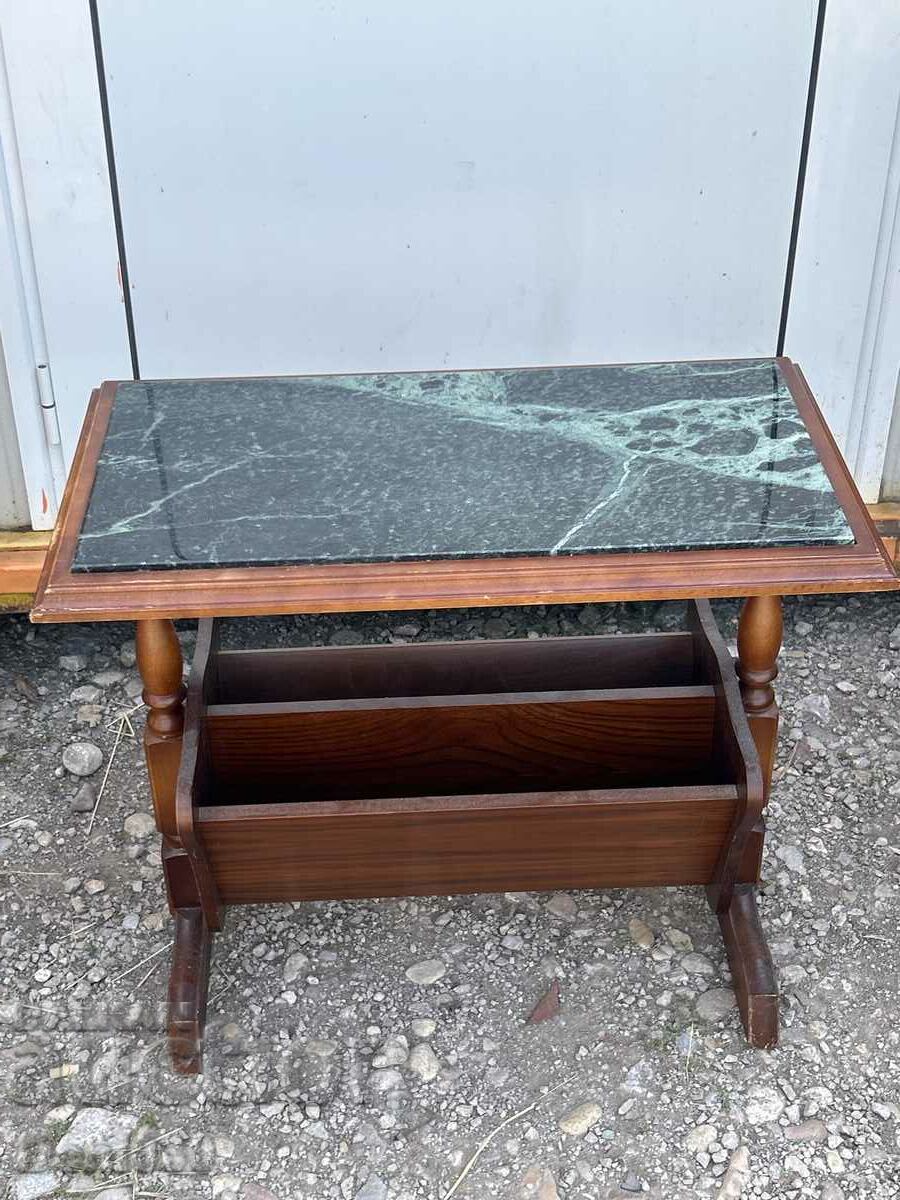 A beautiful coffee table with a magazine rack and a marble top