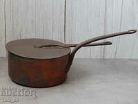 Old copper saucepan with copper lid