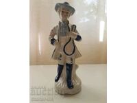 A beautiful porcelain figurine of a musician.