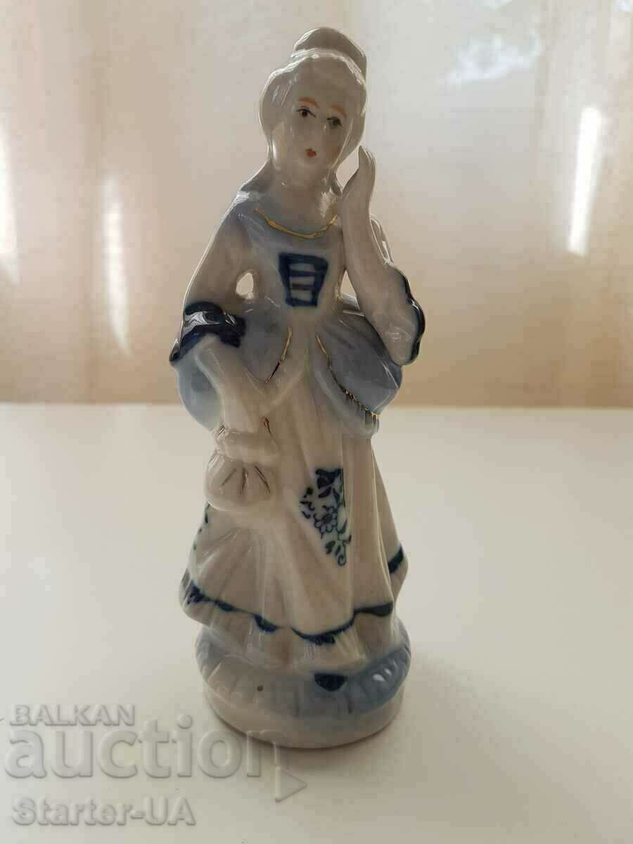 Porcelain figurine of a lady.