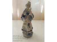 Porcelain figurine of a lady.