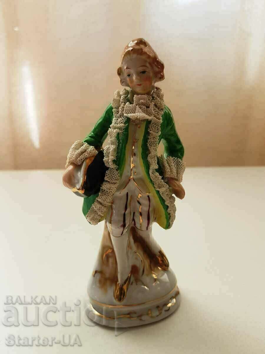 An old porcelain figure of a gentleman.