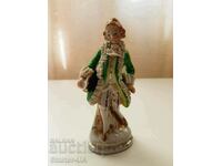 An old porcelain figure of a gentleman.