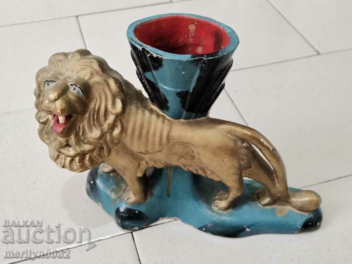 Old ceramic vase with the figure of a lion