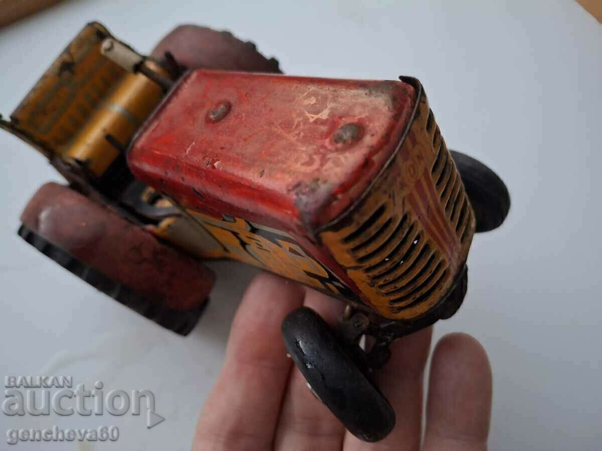 Delivery of Old children's toy - tin tractor Delivery of Old children's toy - tin tractor