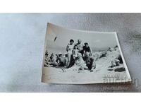 Photo Kiten Men, women and a boy on the beach 1963