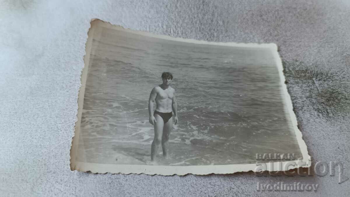 Fotografie Tânăr în costum de baie pe plajă