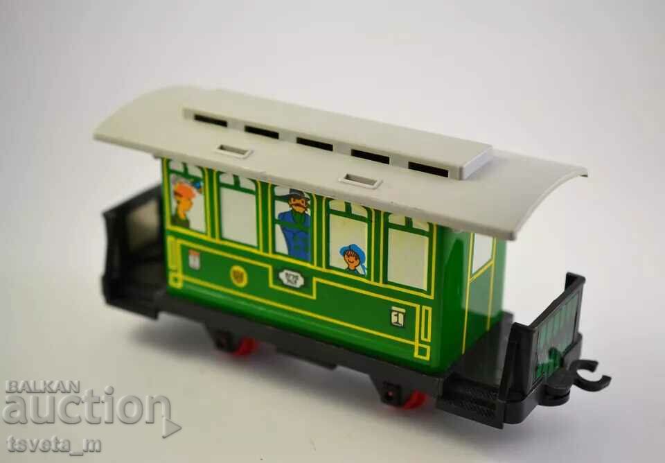 Tin toy railway carriage, social