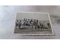 Photo Young men and women on a Corsair boat at sea