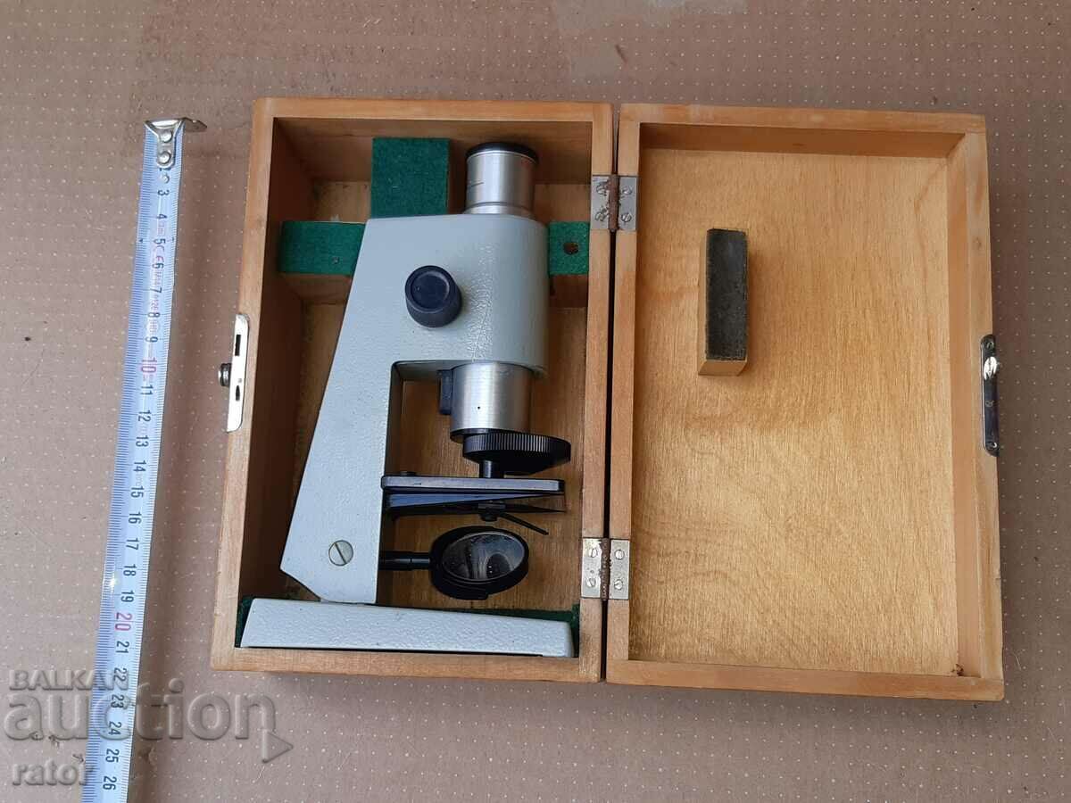Old microscope with wooden case