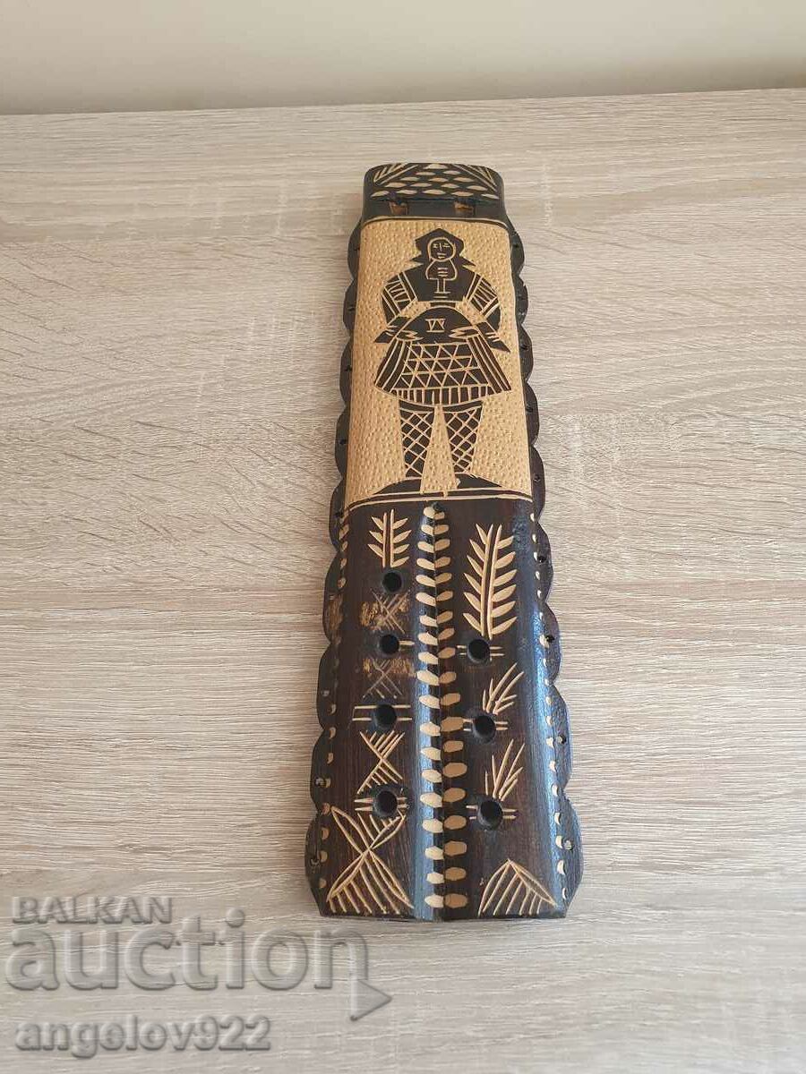 Wooden musical instrument with carving