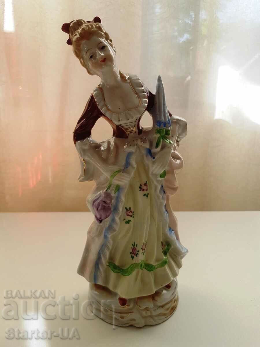 Old Japanese porcelain figure with markings.