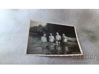 Photo Four men in swimsuits in the river