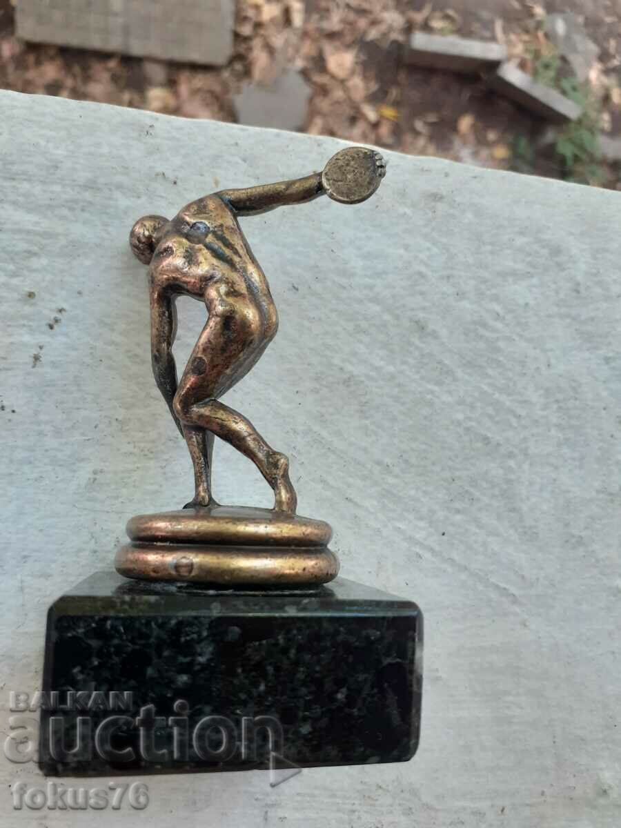 Delivery of A small metal figurine of a discus thrower Delivery of A small metal figurine of a discus thrower