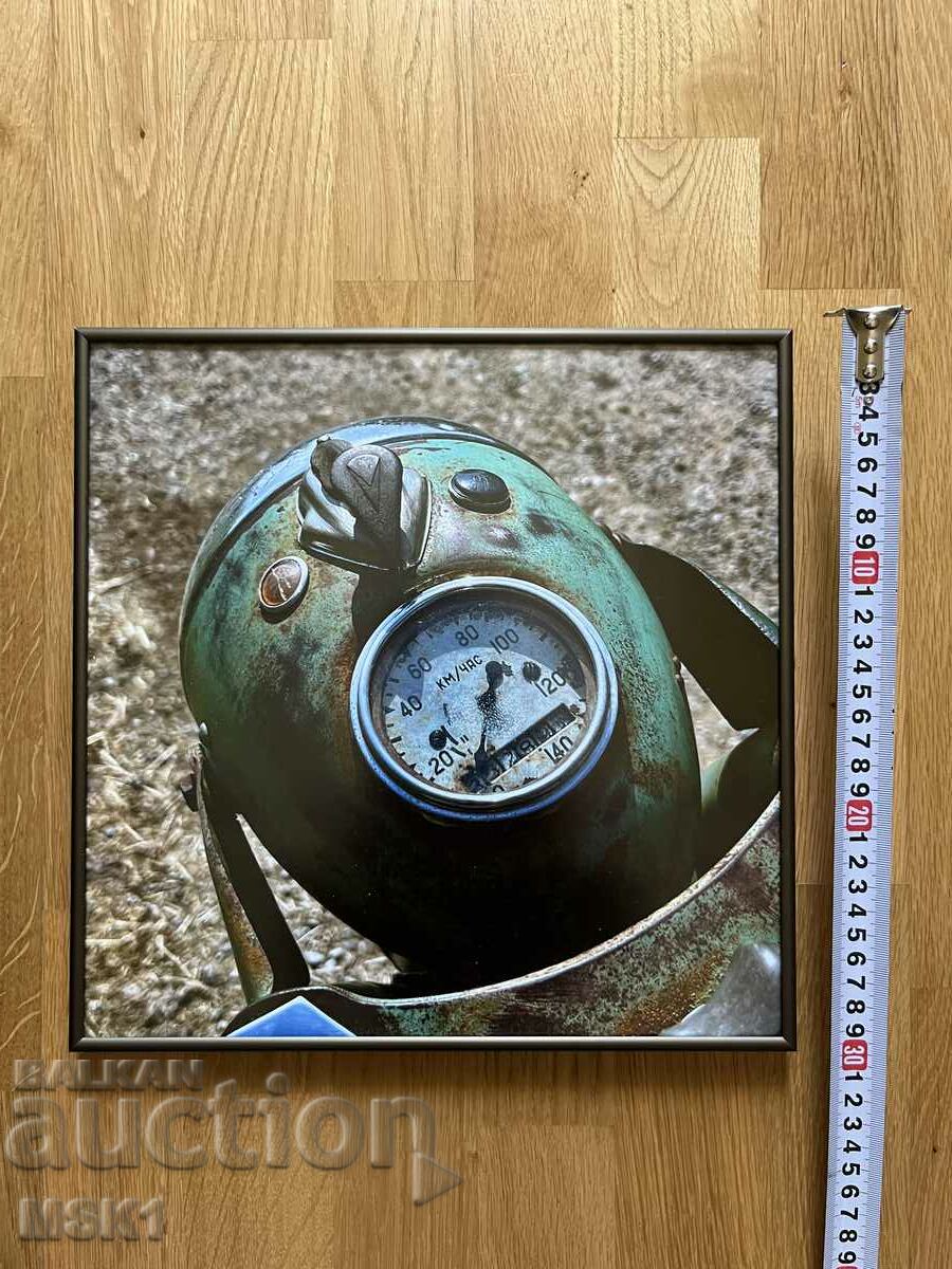 A framed photo of the mileage of an IZH motorcycle