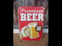 Metal sign beer Premium here is offered served mug