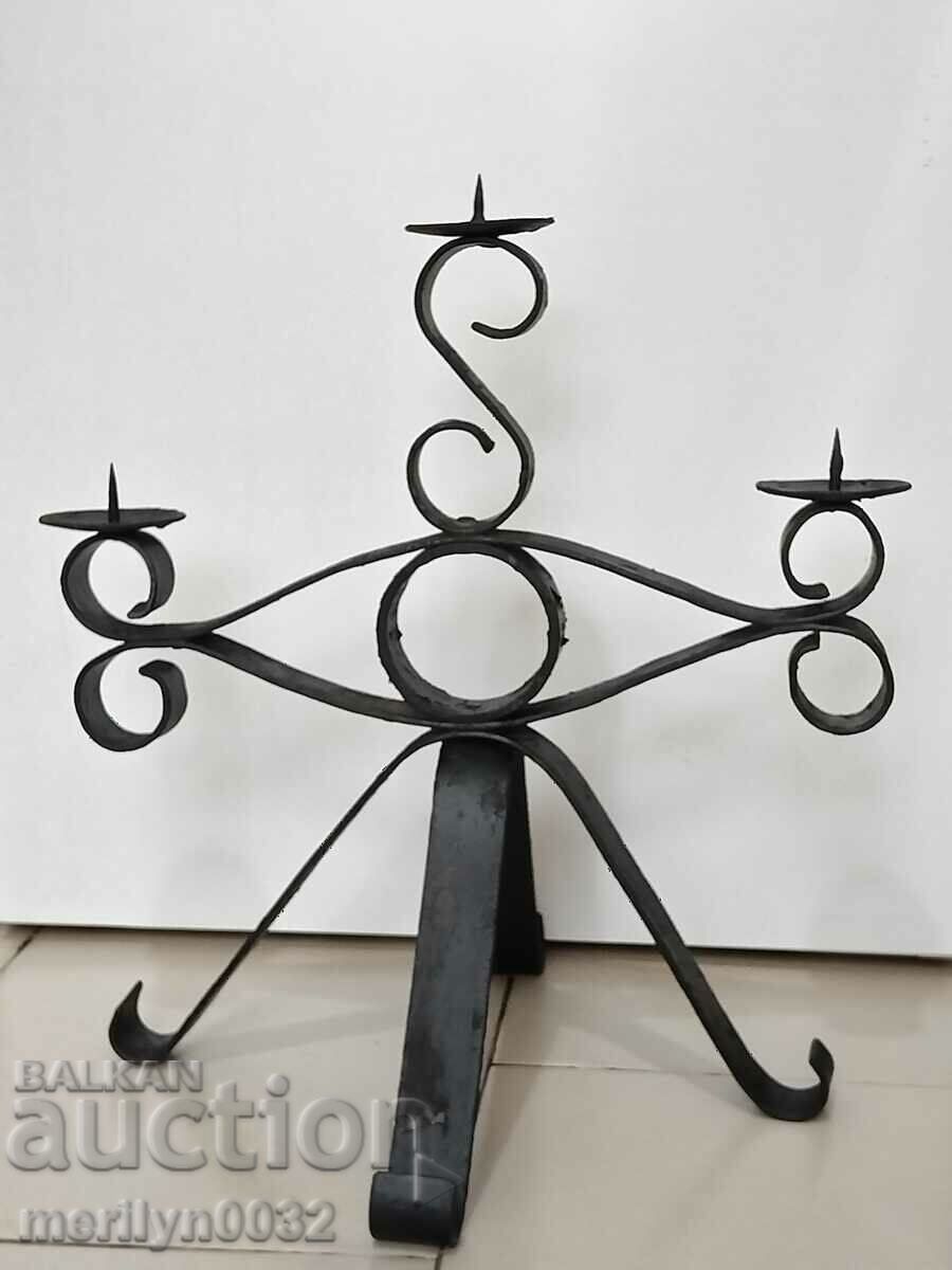 Old forged candlestick, candle