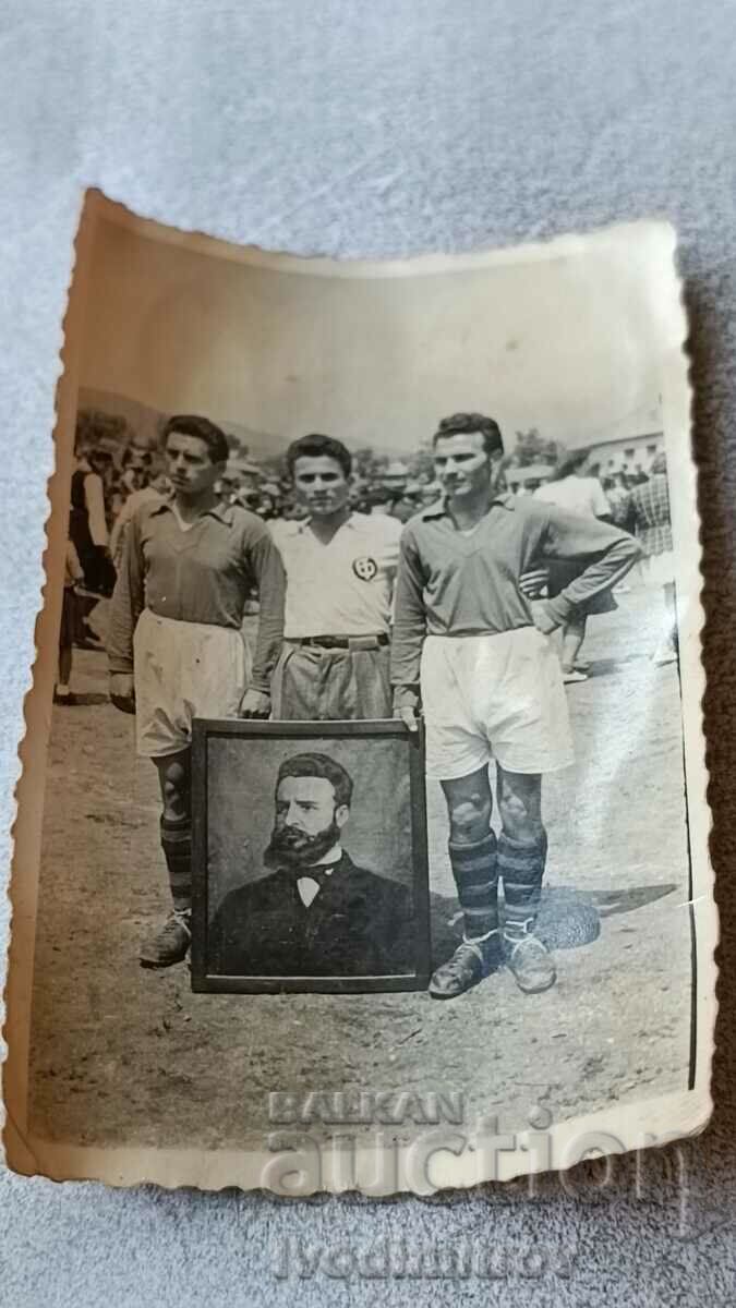 Photo Three athletes with a portrait of Hristo Botev