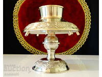 Silver-plated candlestick with embossed vines, marked.