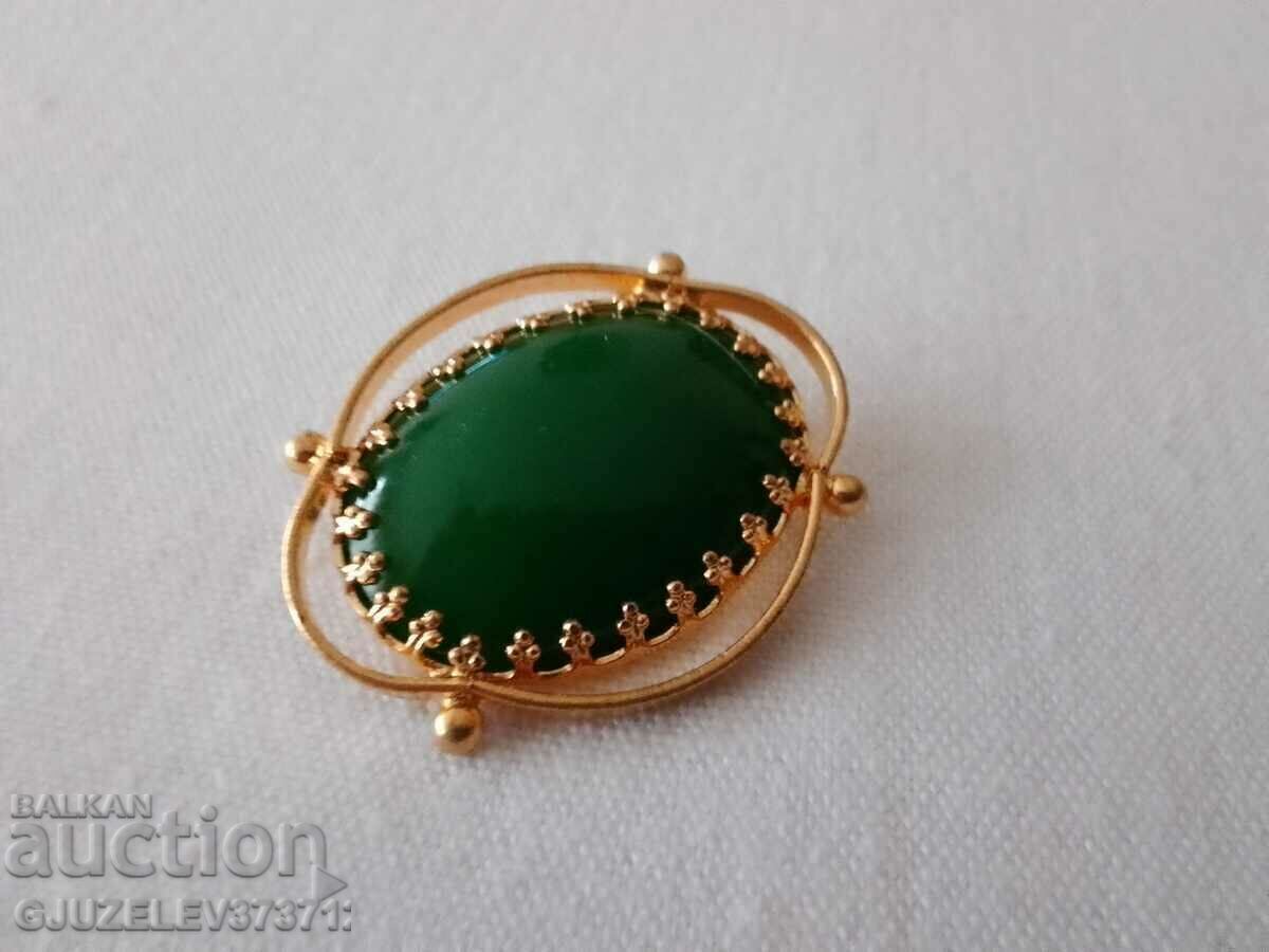 Brass brooch with a dark green variety of agate Brass brooch with a dark green variety of agate
