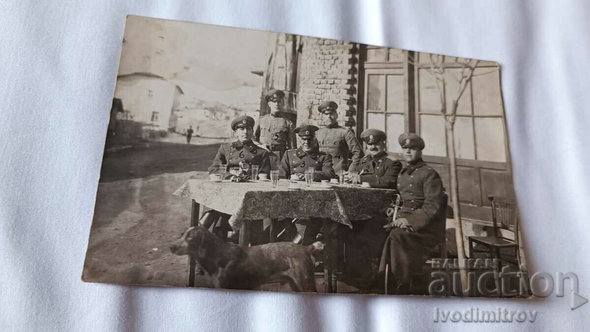 Photo Six Border Guard officers sitting at a table