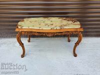 An exceptional coffee table with rich wood carving and an onyx top!