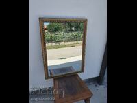 A large mirror in a massive wooden frame!!!