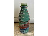 Old wicker bottle with braid, bottle glass jar