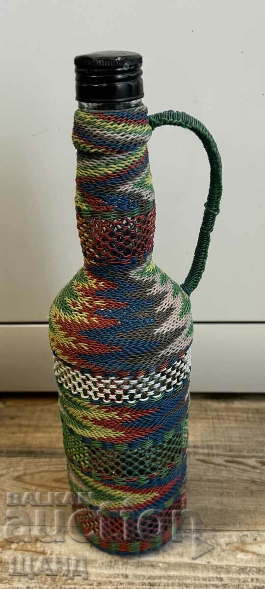 Old wicker bottle with braid, bottle glass jar